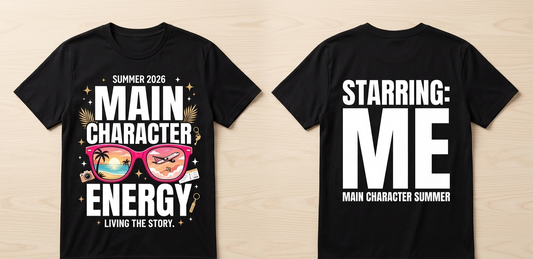 Black t-shirt with 'Summer 2026 Main Character Energy' design on front and 'Starring: Me Main Character Summer' text on back, on a wooden surface.